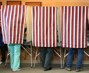 people in a voting booth