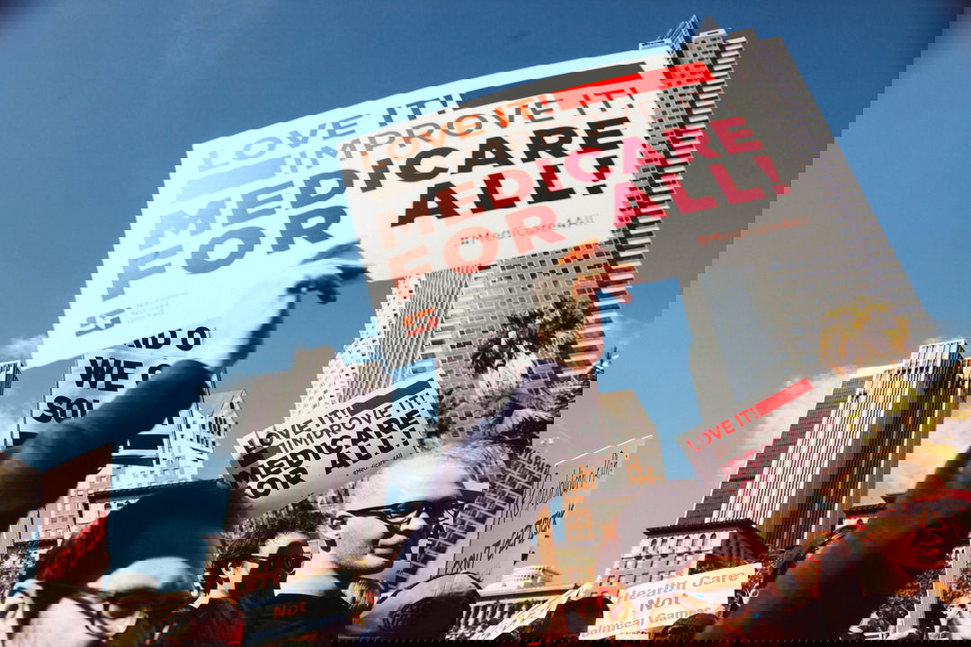 medicare for all sign at a protest
