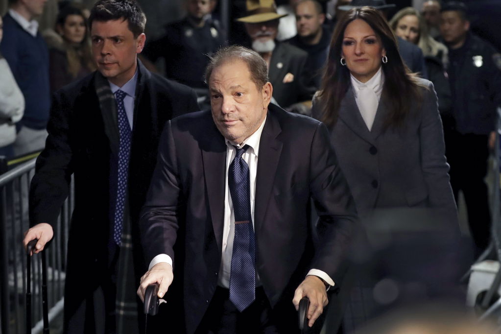 Harvey Weinstein in front of a Manhattan courthouse with his legal team